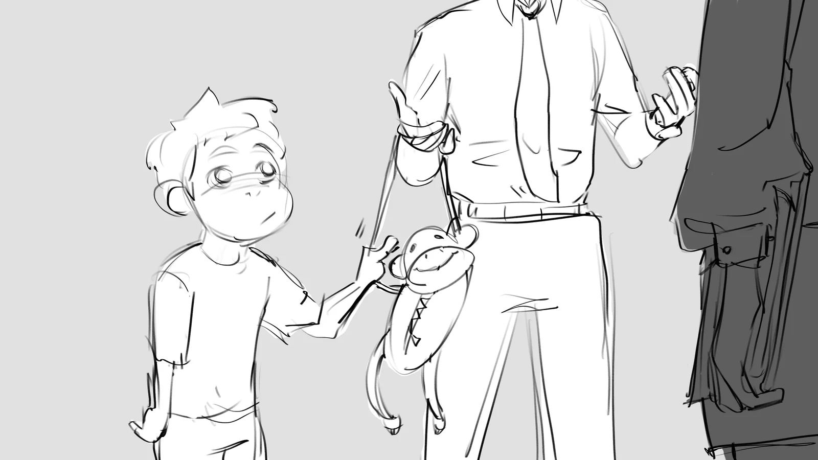 A boy holds up a small toy to an adult while another stands behind