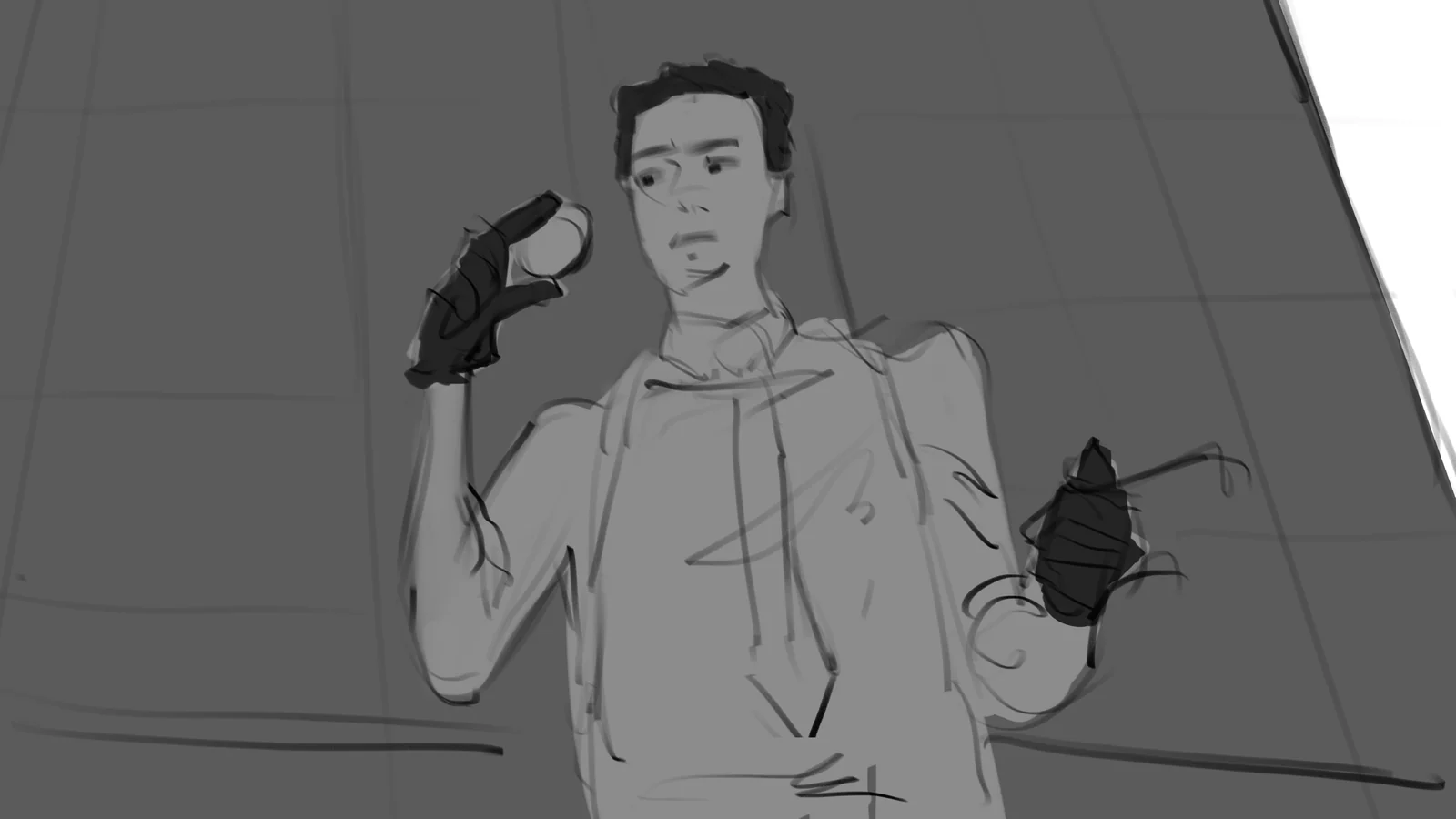 A young man in a hoodie holds up a small object against a tiled wall
